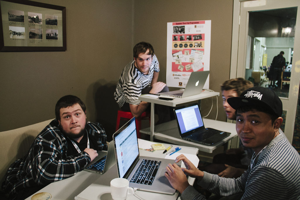 A group of young men, all looking at the camera, pulling faces